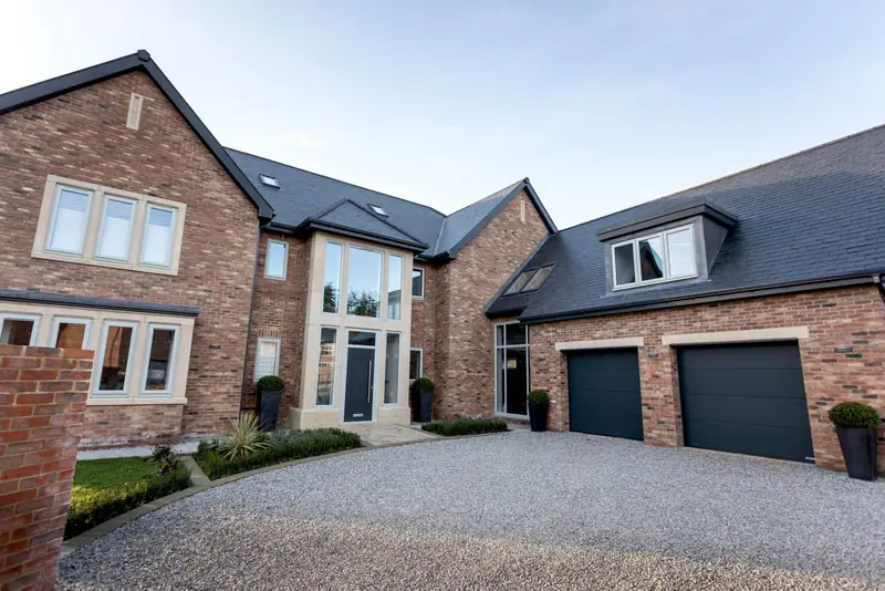 Brick-built detached house with a gravel driveway