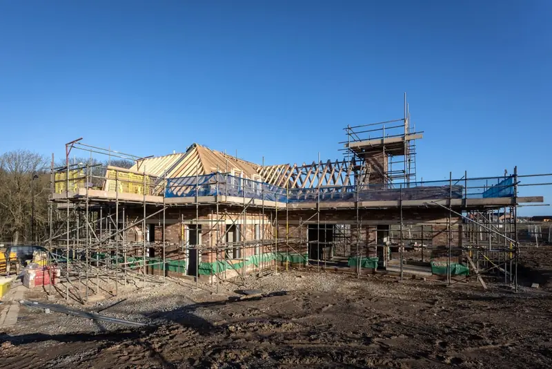 Self-build home under construction with scaffolding